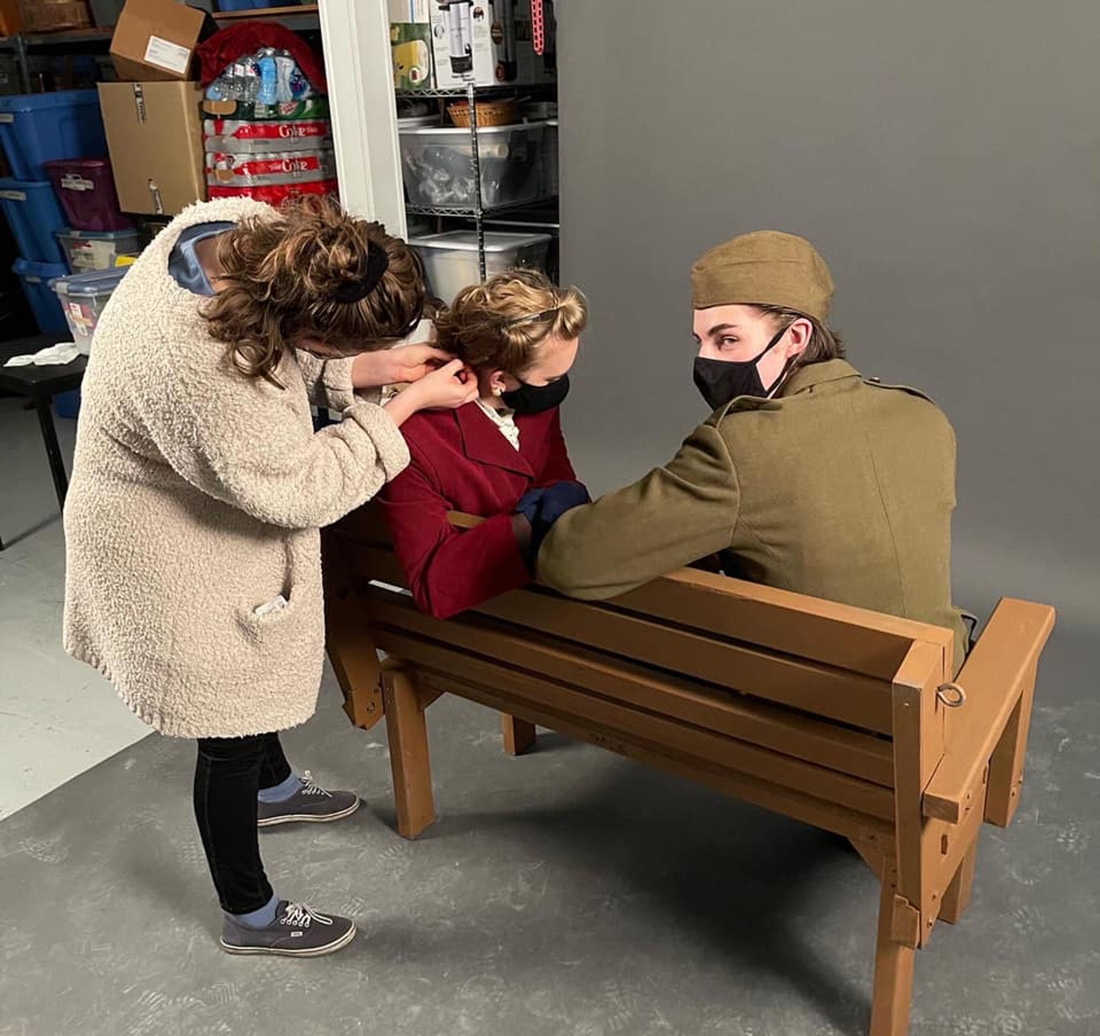 Nicola Shannon fixes Cassie Unger's hair during the Last Train to Nibroc photoshoot