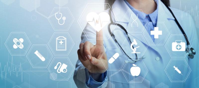A clinician interacts with a transparent overlay of health-related icons, suggesting multiple dimensions of well-being.