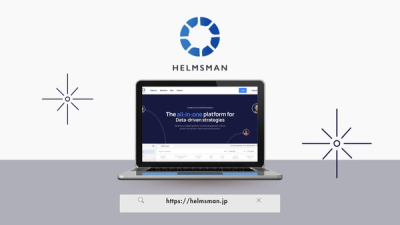 An image of a laptop showing the Helmsman website, and the Helmsman logo above the laptop.