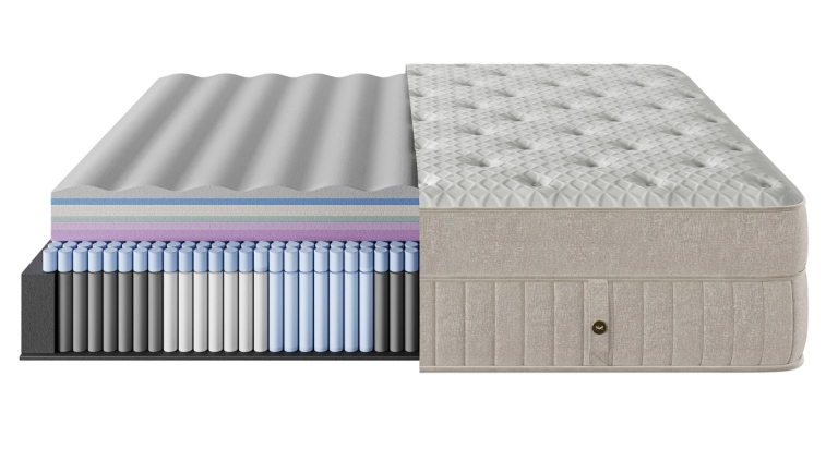 Cutaway view of a mattress revealing internal foam, spring layers, and a quilted exterior.