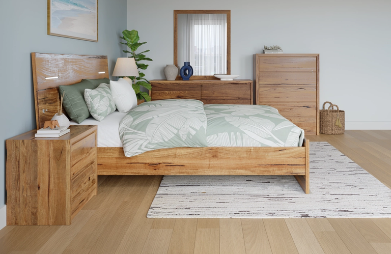 A natural wood bedroom set, including a bed with an illuminated headboard, nightstand, dresser, and chest of drawers, with light green leaf-patterned bedding.