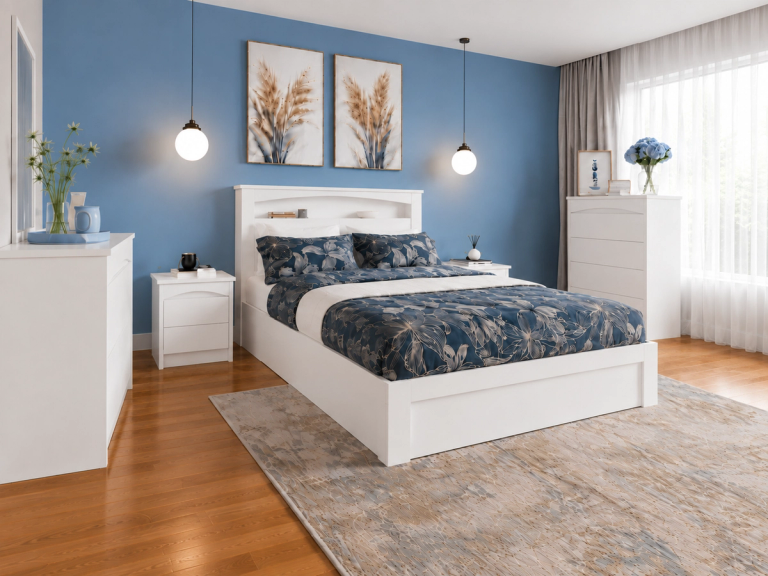 A bedroom with blue walls, white furniture, and blue floral bedding.