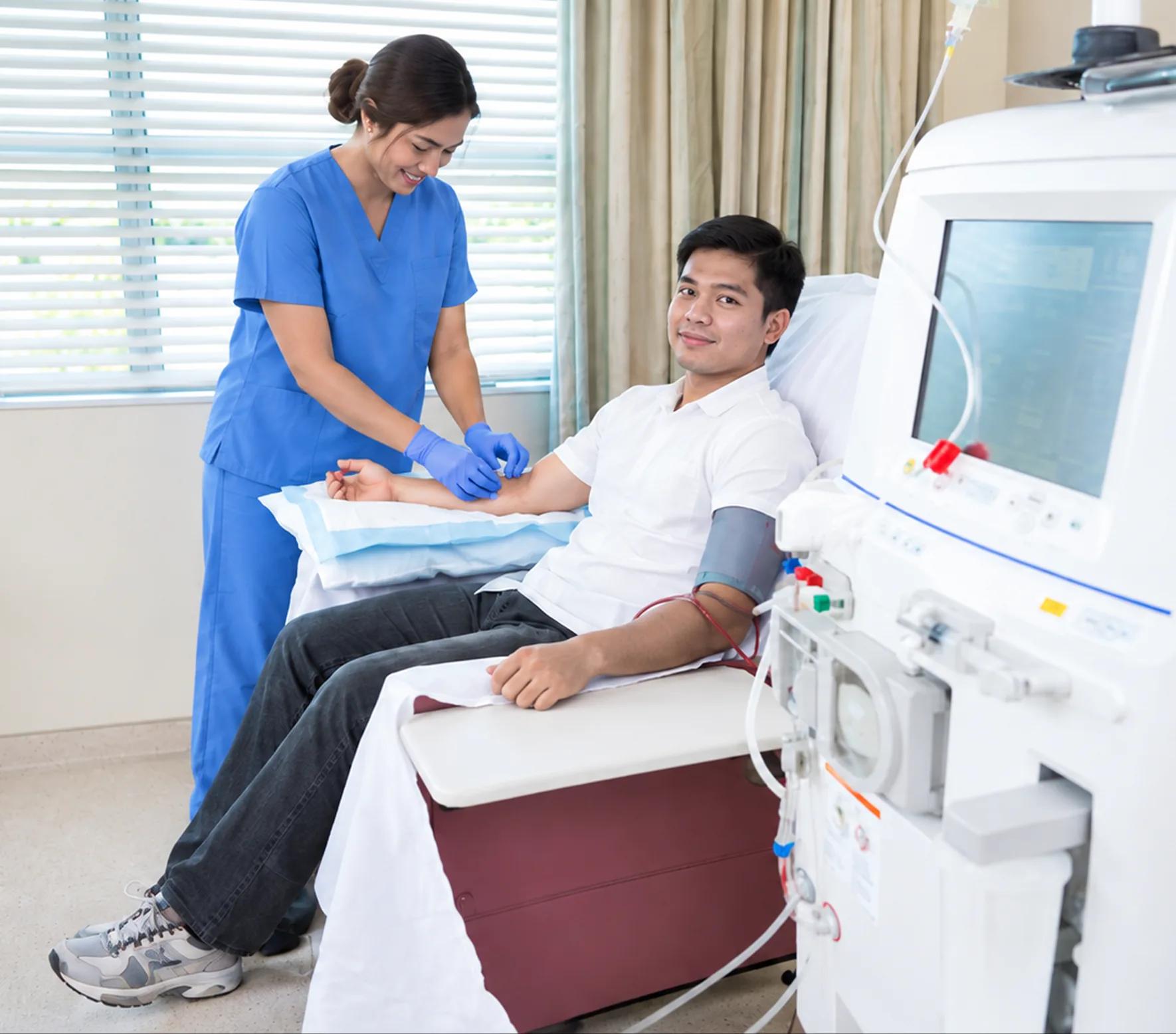Nurse preparing a patient for hemodialysis