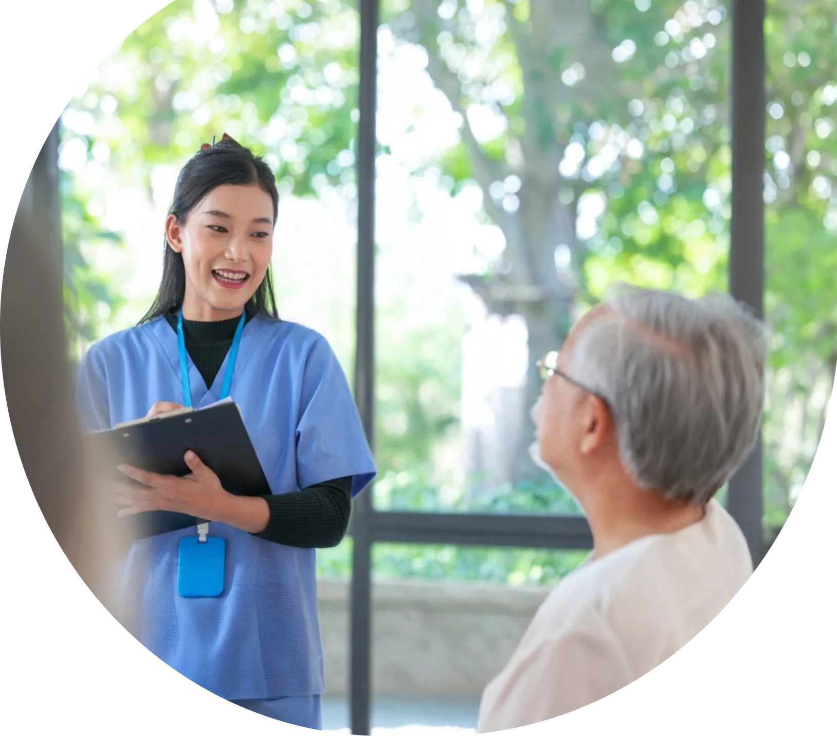 Nurse with clipboard talking with an elderly patient