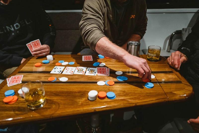 A group of people playing cards in a lindell