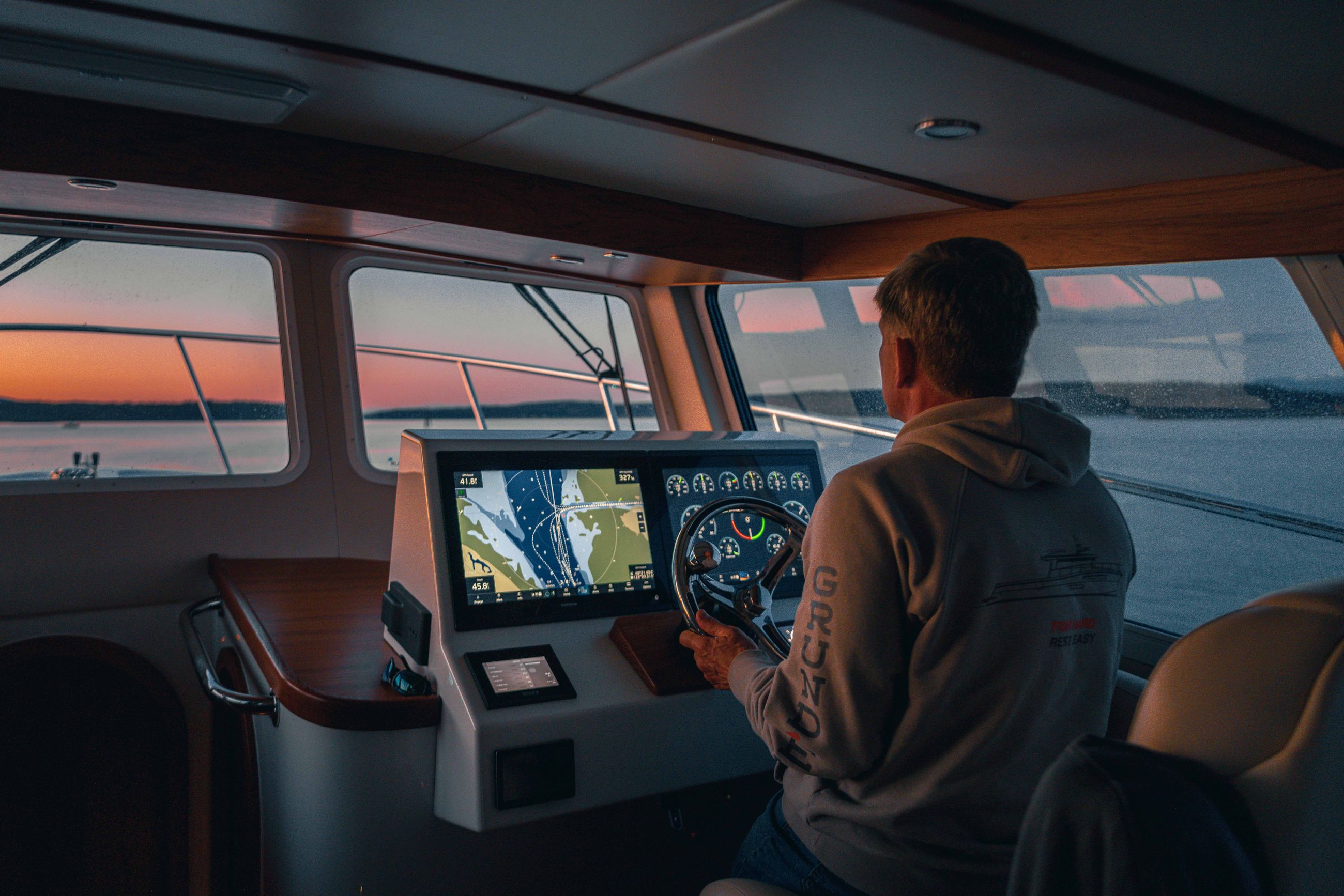 President of Lindell Yachts Mark Fritzer at the helm of the Lindell 42 at sunset