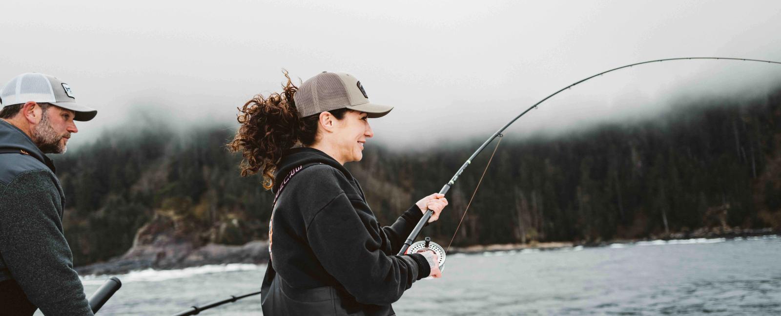 A photo of someone fishing off the back of a Lindell