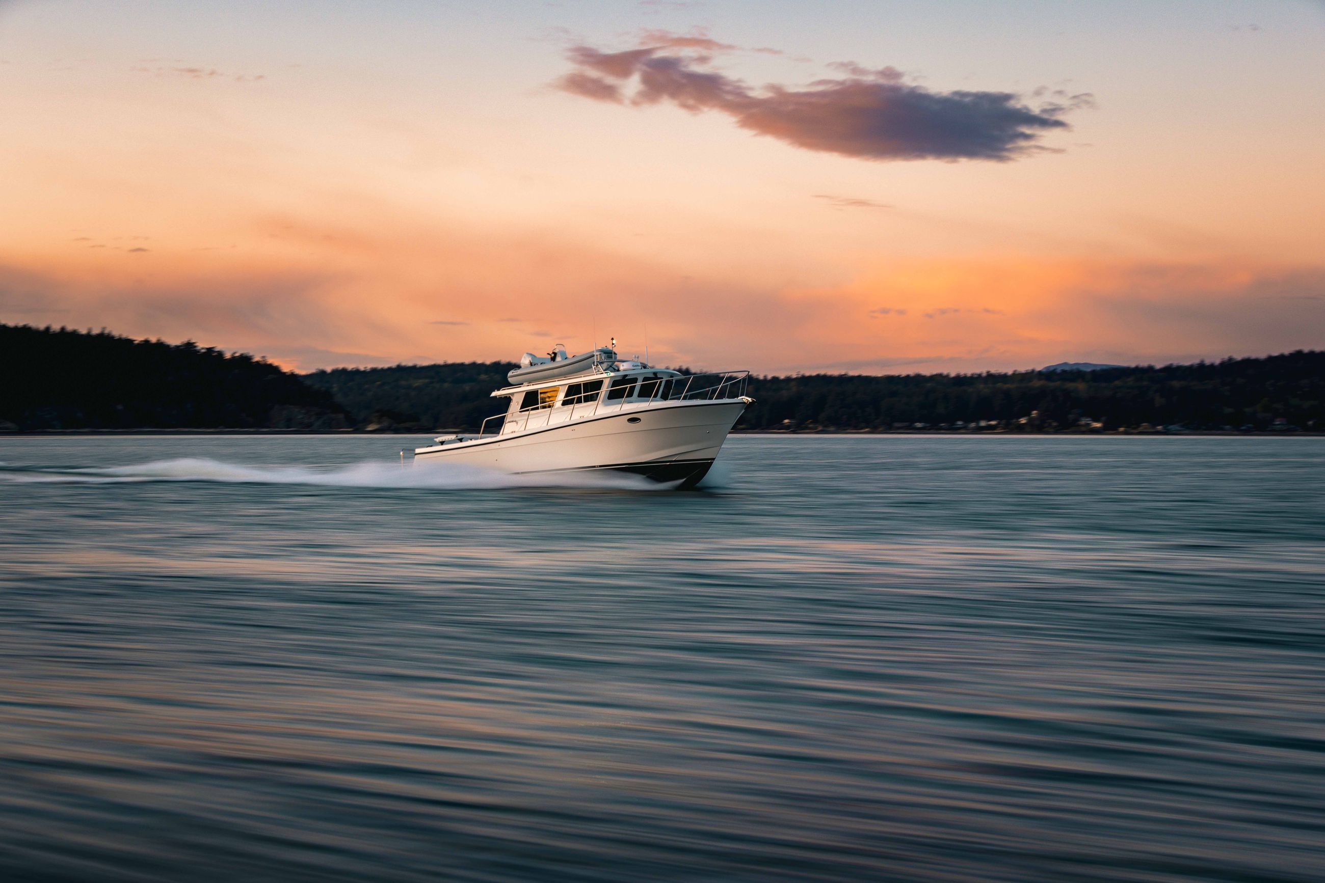The Lindell 42 at full speed as the sun sets behind it