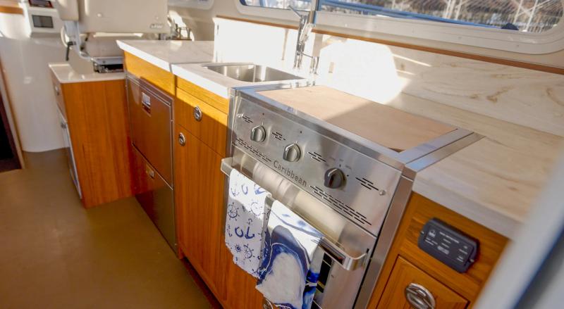 The galley in the lindell 42 featuring a sink, grill, stove, and oven