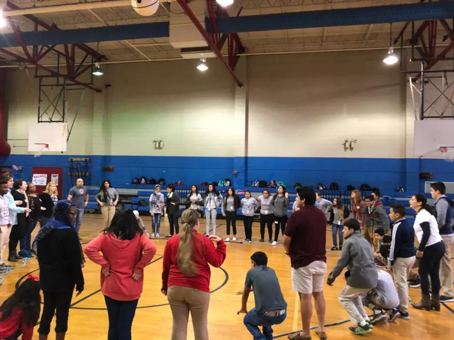 Students taking part in a group activity in a gym