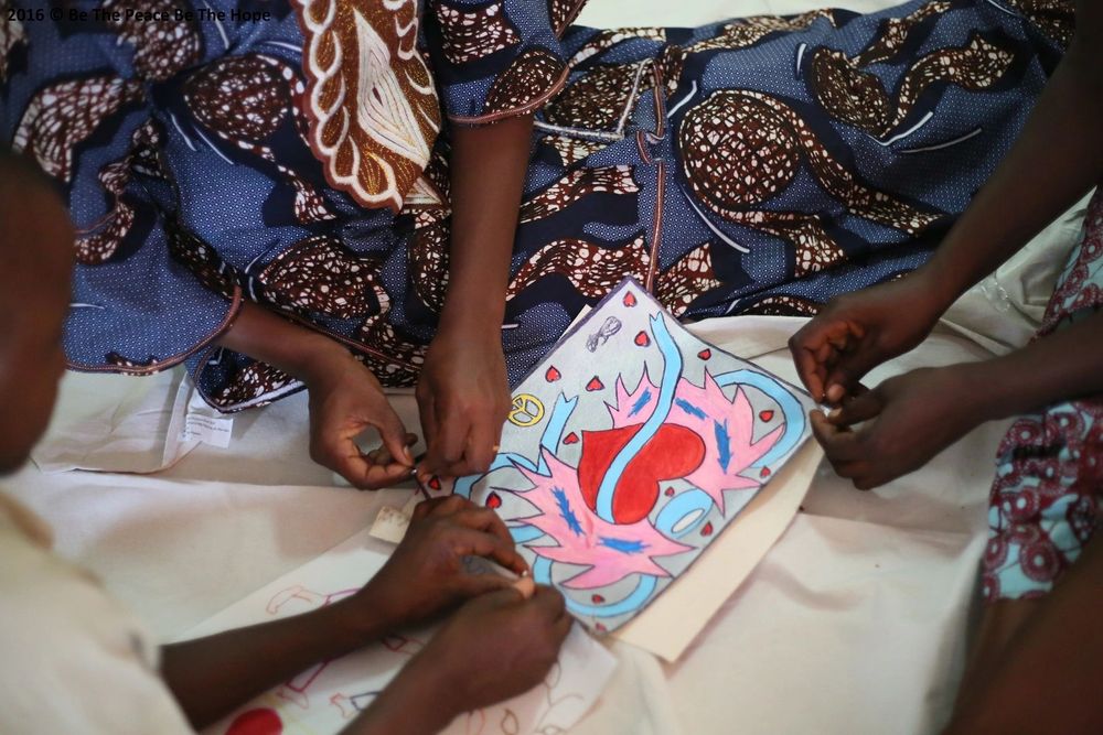 Children’s hands around a drawing of a heart