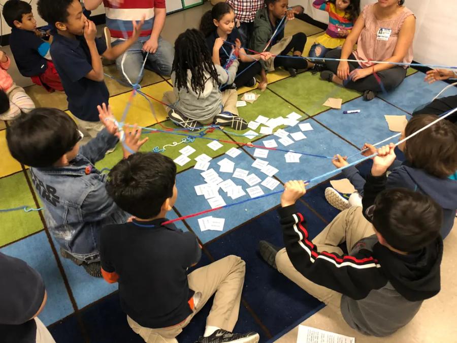 Students sitting in a circle on a classroom rug