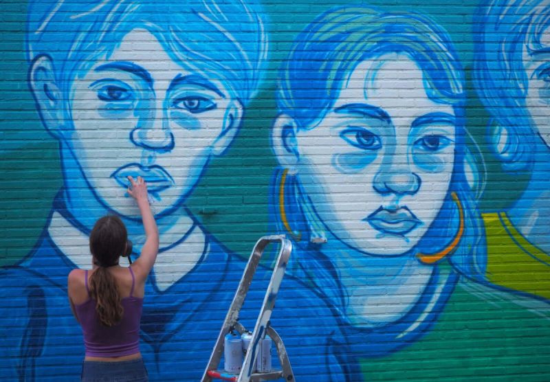 Amélie Zimmermann at work on the cut 11 percent mural