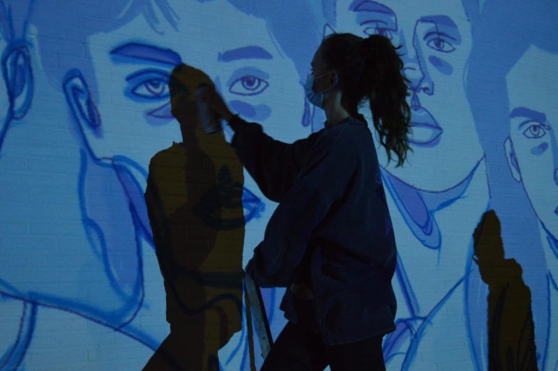Amélie Zimmermann working on the cut 11 percent mural during night shift