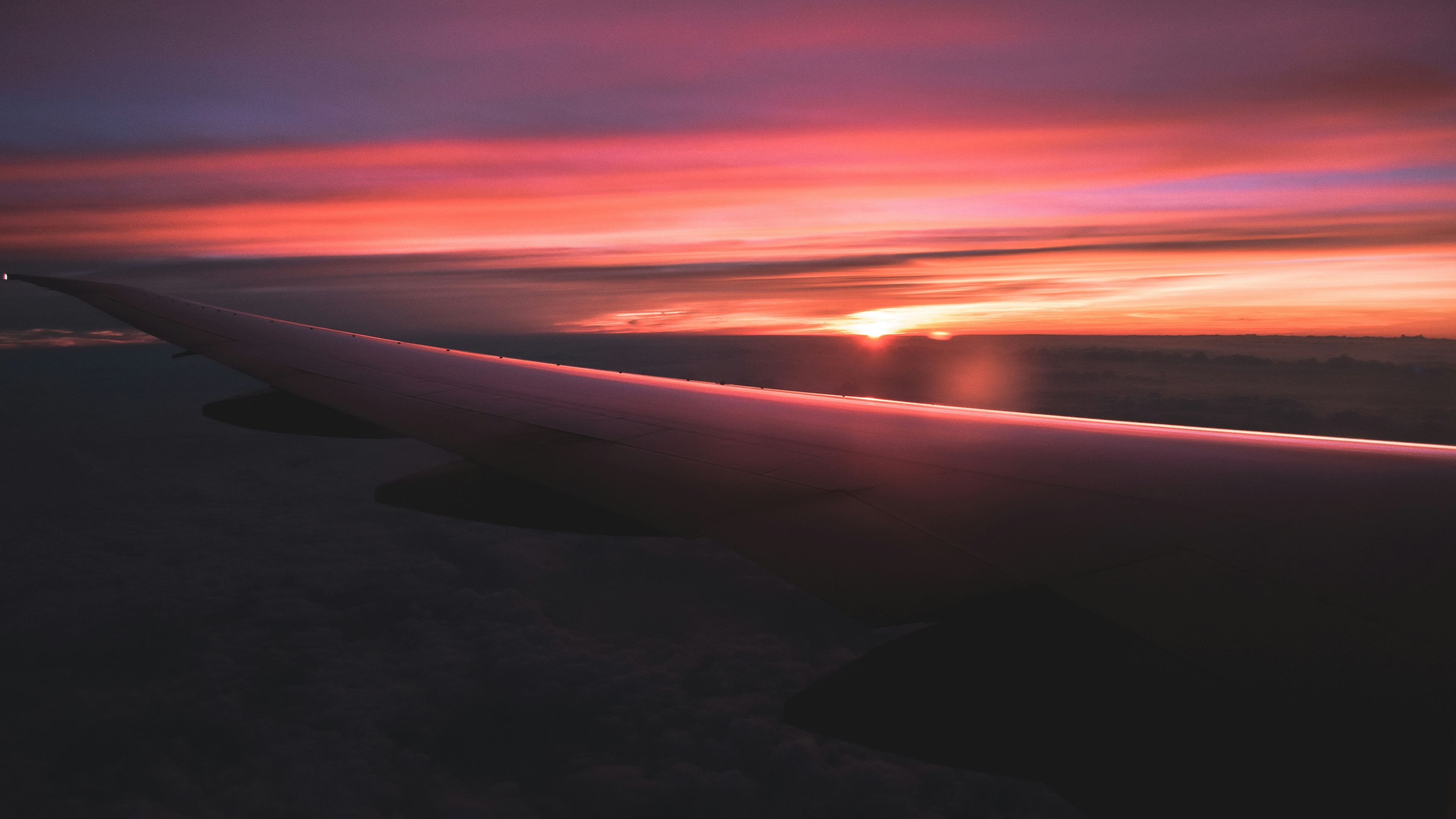 A sunset over a long beach