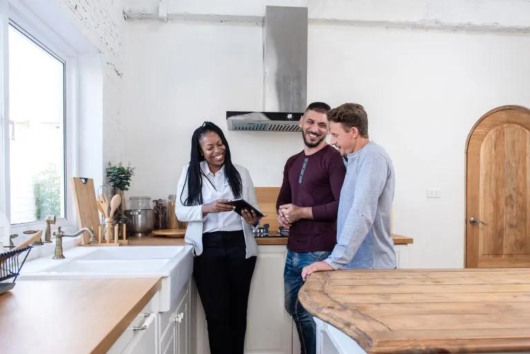 Real estate agent showing a couple around a new house