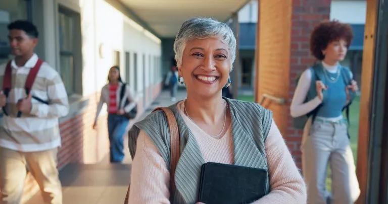 Confident teacher portrait in a school setting