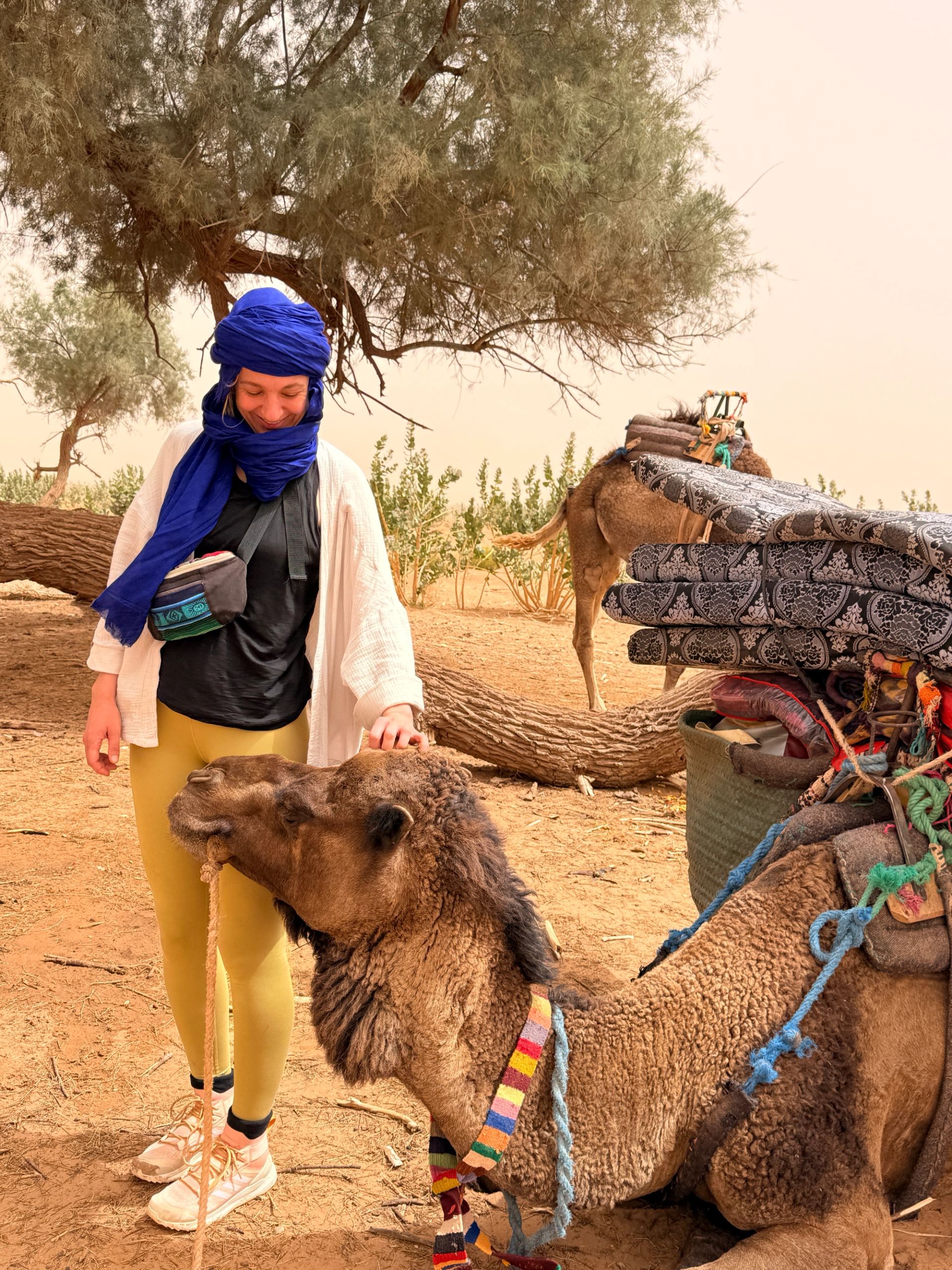 Two travellers with backpacks on the move in the desert