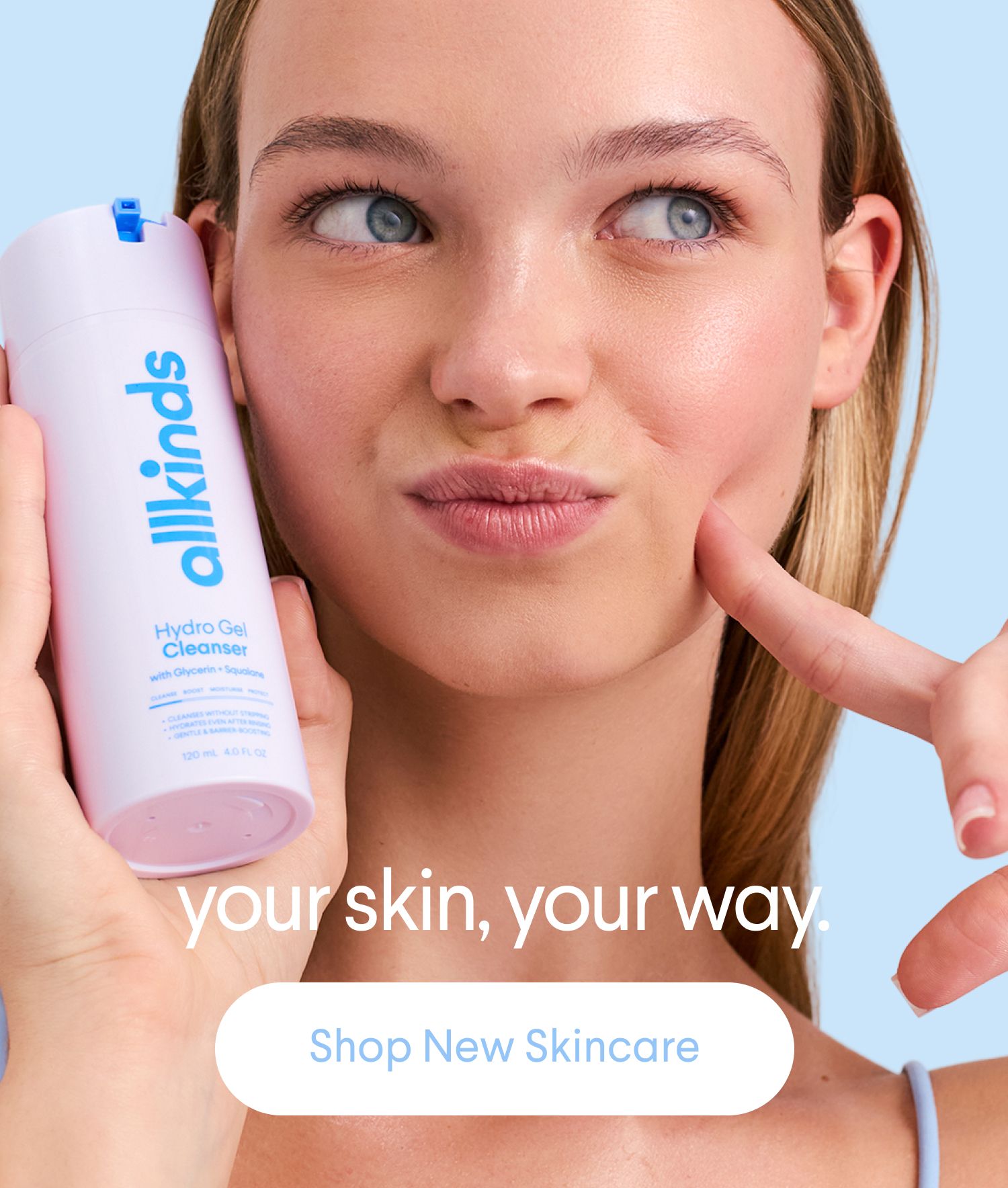 Young woman holding pink "allkinds Hydro Gel Cleanser" and pointing to her cheek. Text: "your skin, your way."