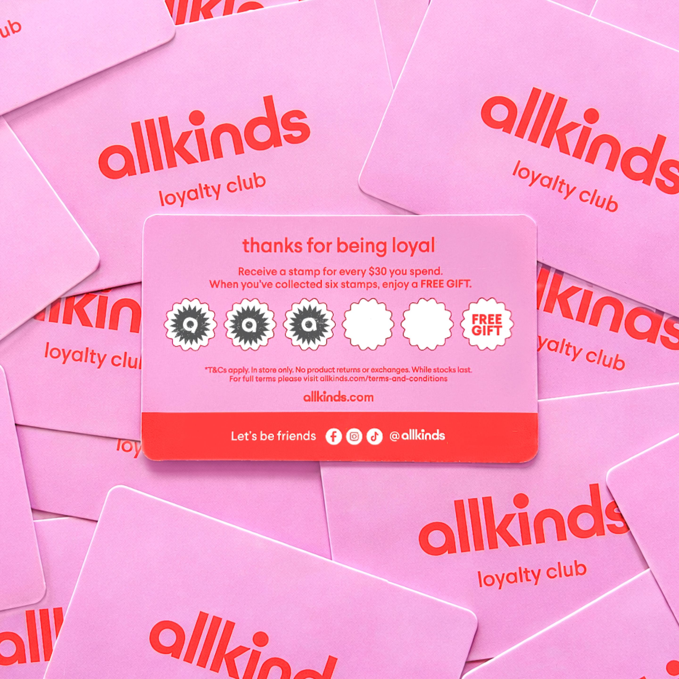 A stack of pink "allkinds loyalty club" cards, with one card's back showing a stamp-based rewards program.