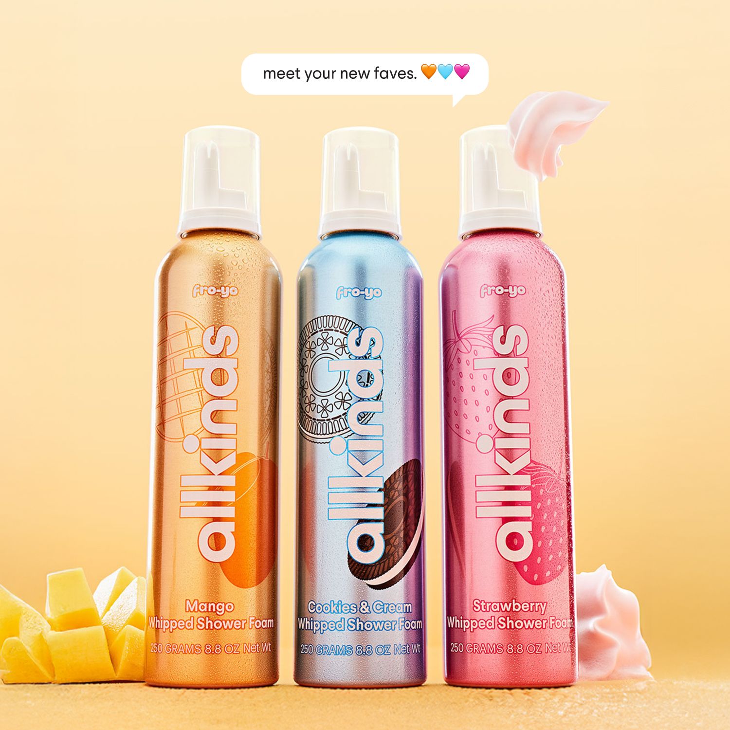 Three allkinds whipped shower foam bottles (Mango, Cookies & Cream, Strawberry) with related ingredients and a speech bubble saying 'meet your new faves. 💙🧡💖'
