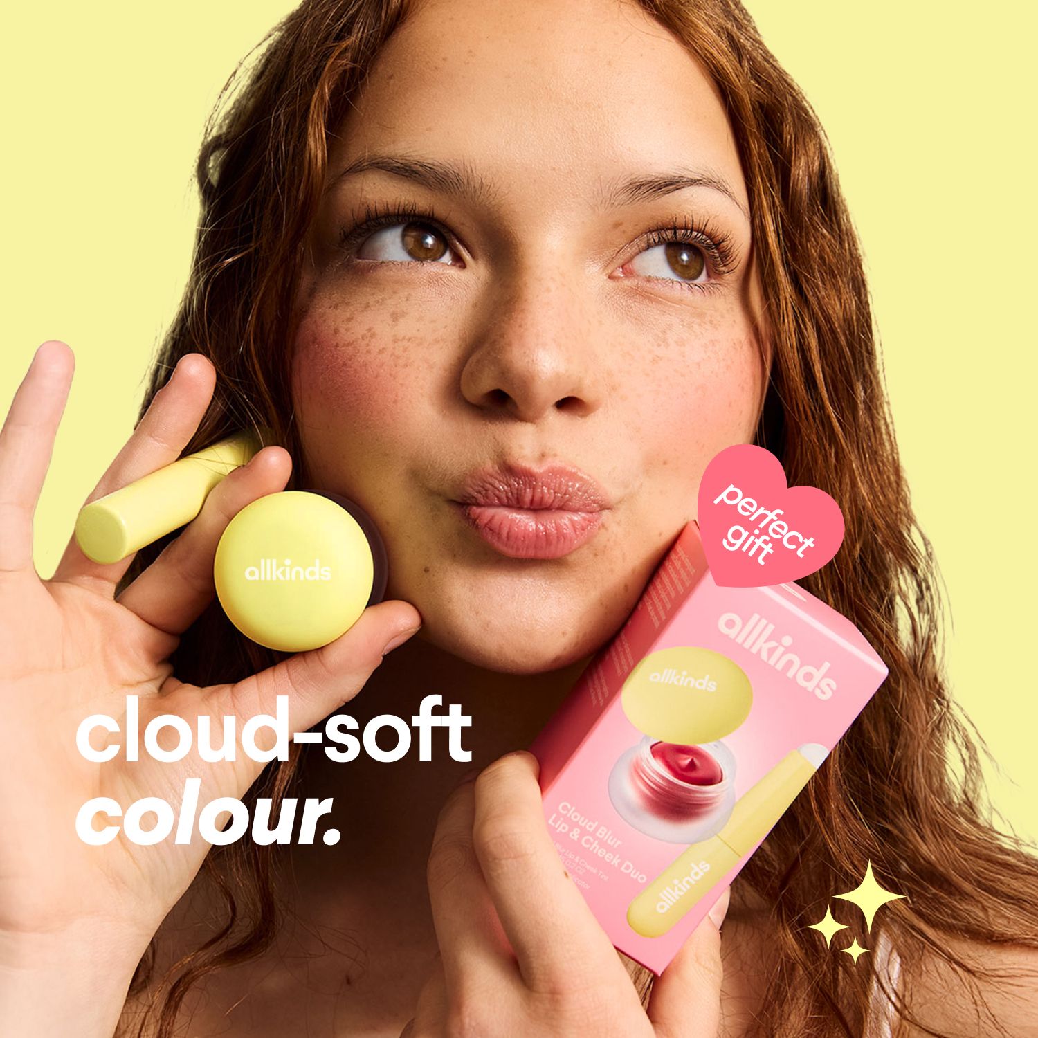 a woman is holding a lip balm and a box of lip balm .