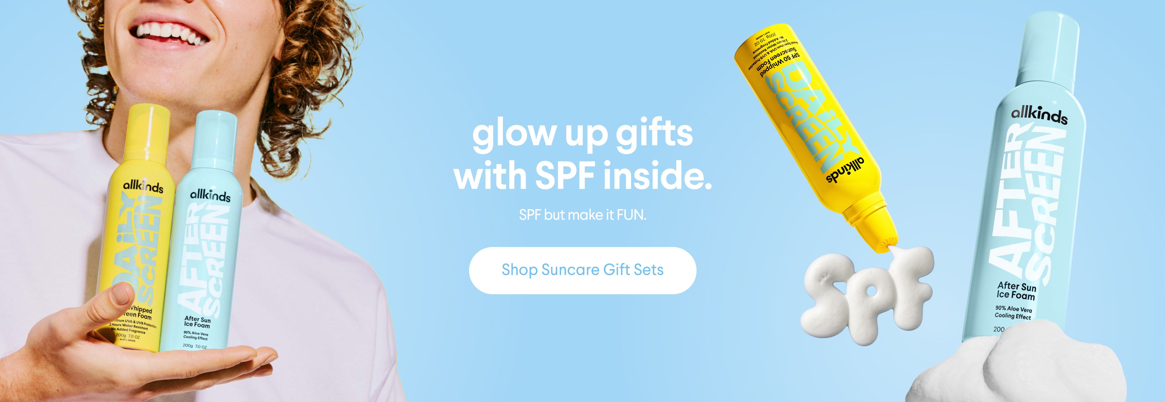 a man is holding two bottles of sunscreen in his hand .