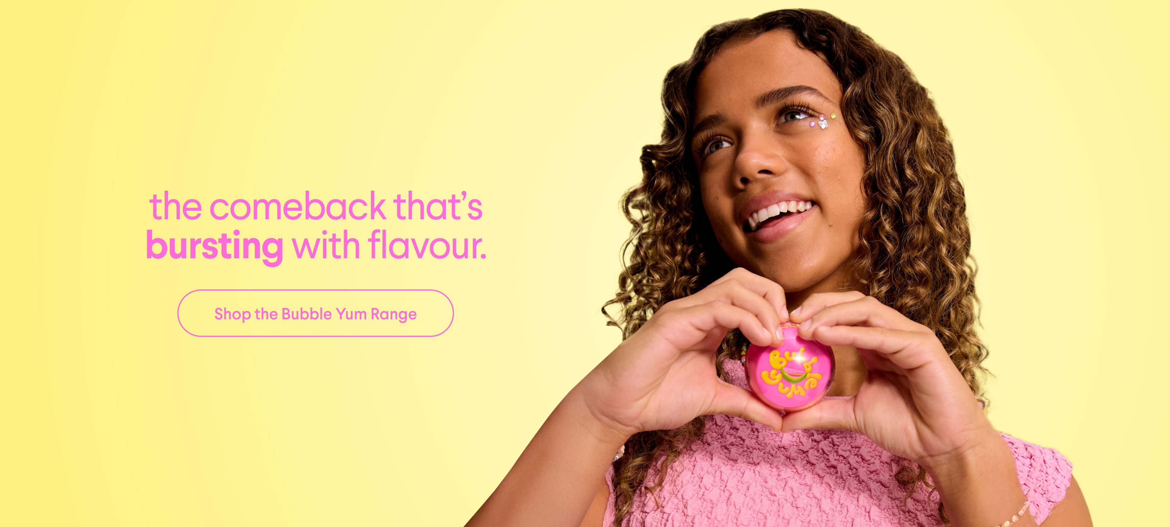 a young girl is making a heart shape with her hands .