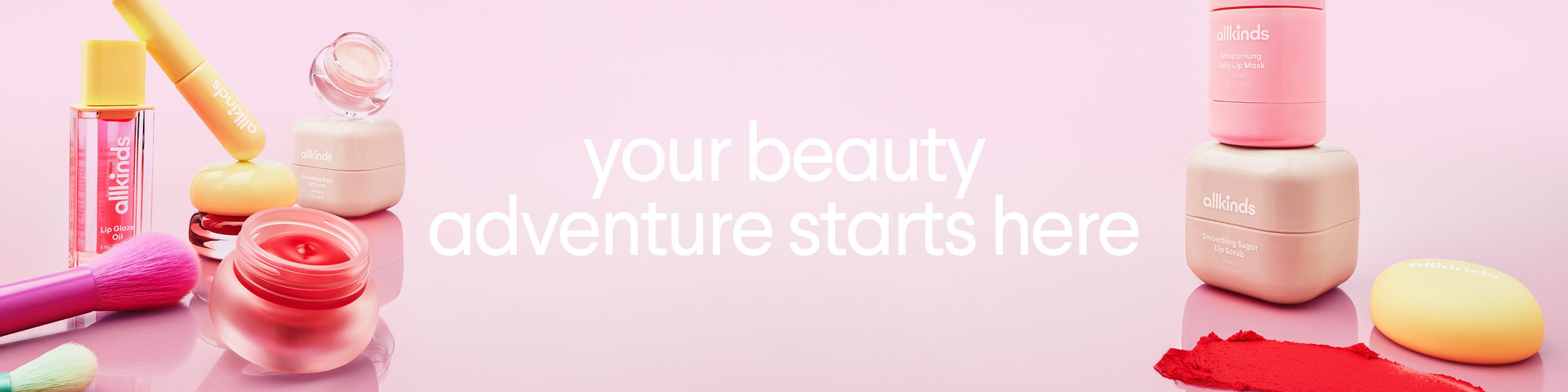 a pink background with a bunch of cosmetics and the words `` your beauty adventure starts here '' .
