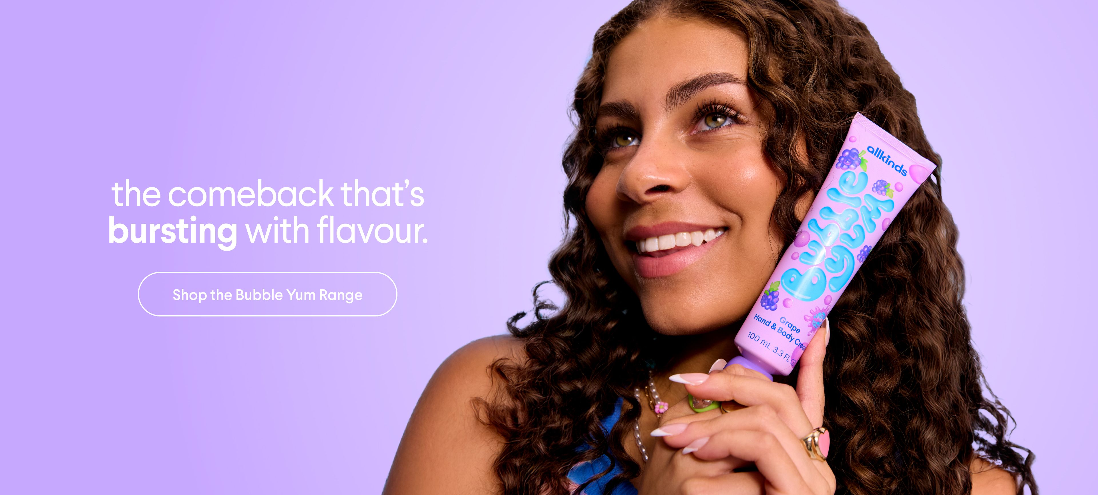 a woman is holding a tube of bubble gum in her hand .