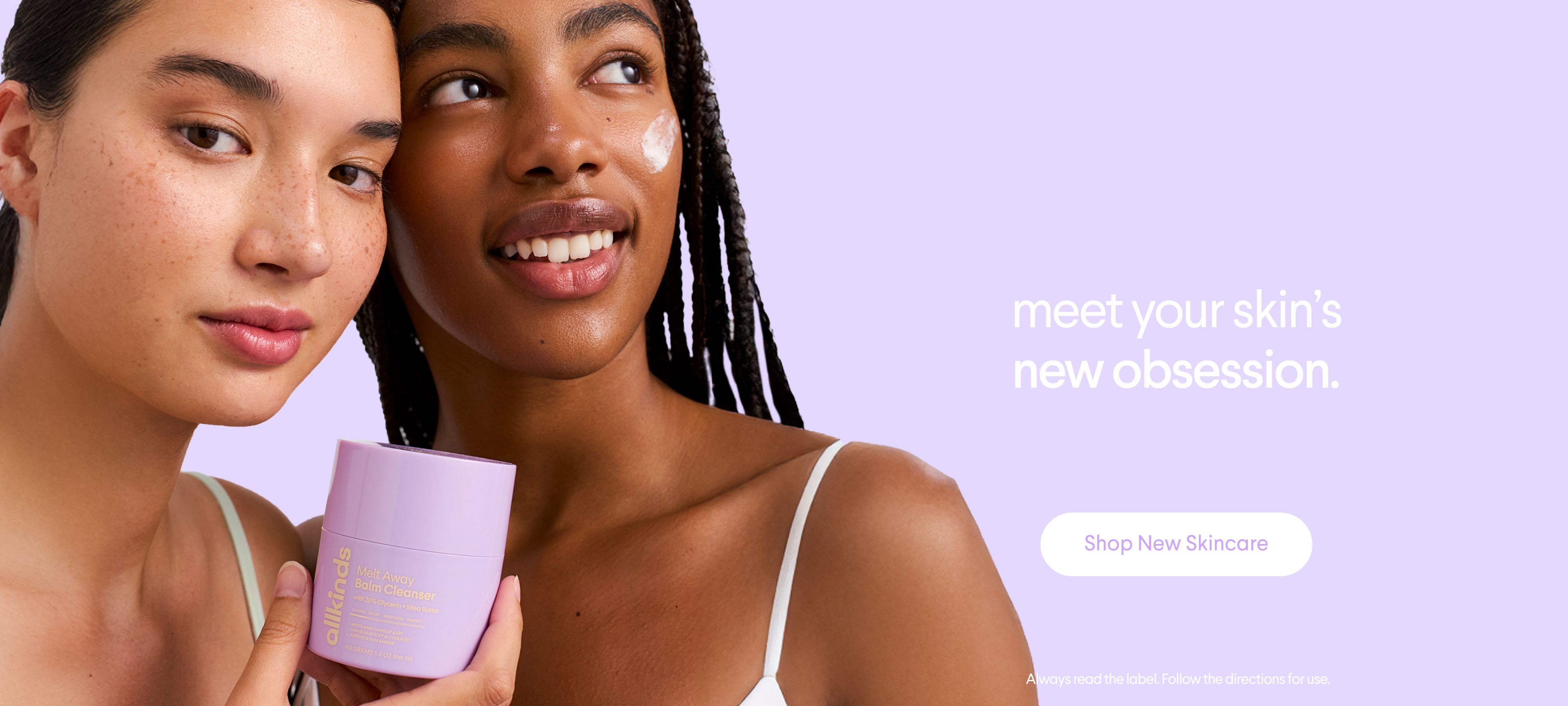 Two women with glowing skin, one holding a purple skincare jar and the other with cream on her cheek, next to text "meet your skin's new obsession." and a "Shop New Skincare" button.