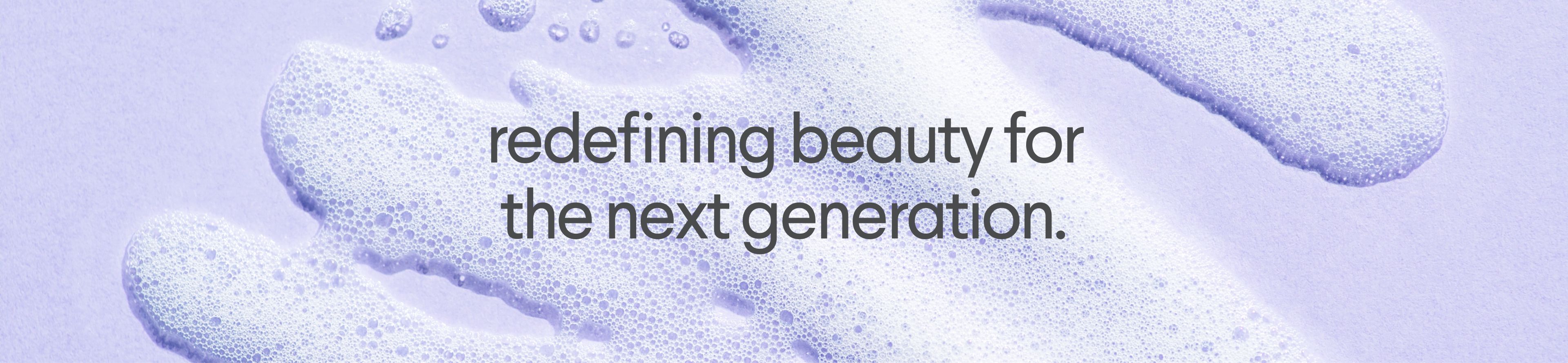 Light purple background with foamy purple textures and the text "redefining beauty for the next generation."