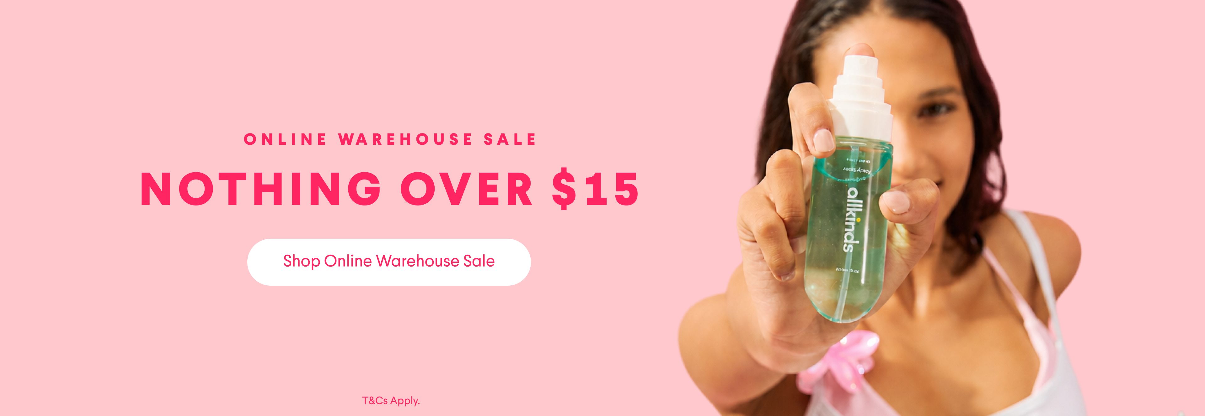 A smiling woman holds a green spray bottle on a pink background next to text: "ONLINE WAREHOUSE SALE NOTHING OVER $15. Shop Online Warehouse Sale."