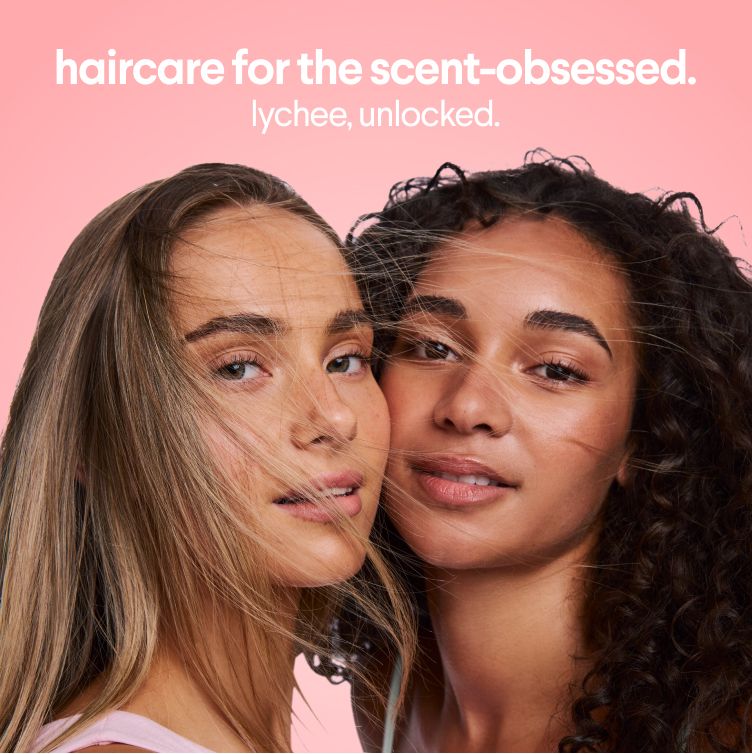 Two young women with soft, flowing hair. Text: "haircare for the scent-obsessed. lychee, unlocked."