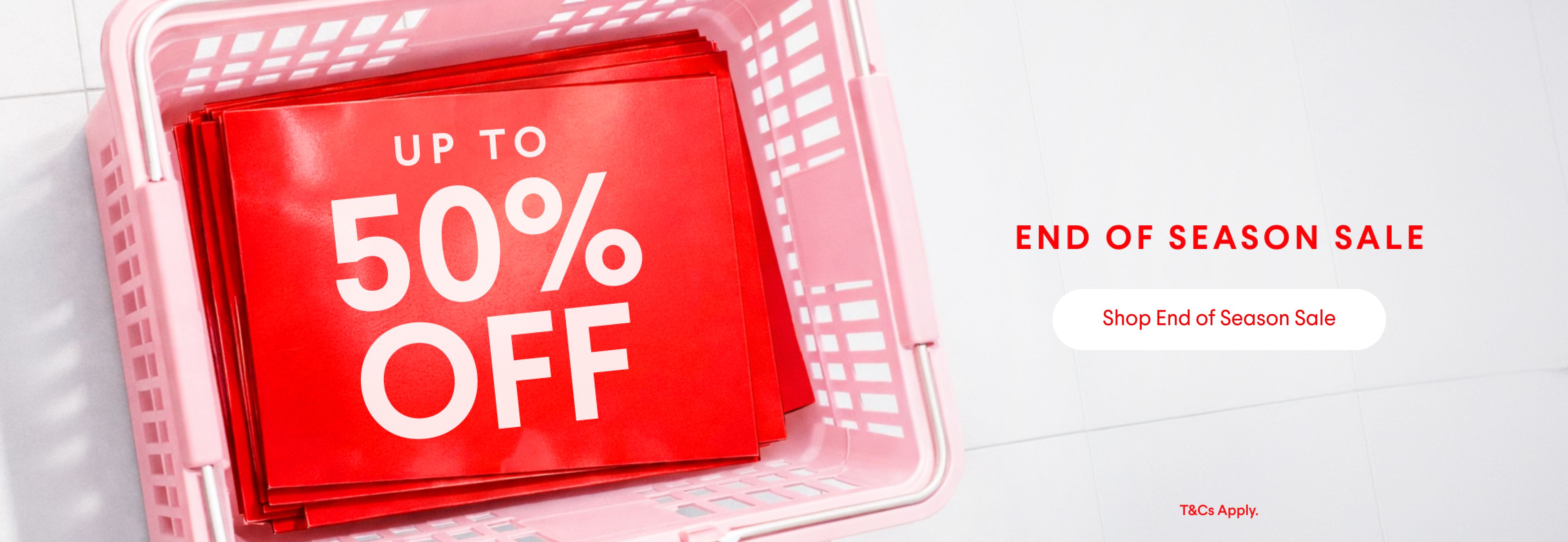 Pink shopping basket filled with "Up to 50% Off" signs for an End of Season Sale.