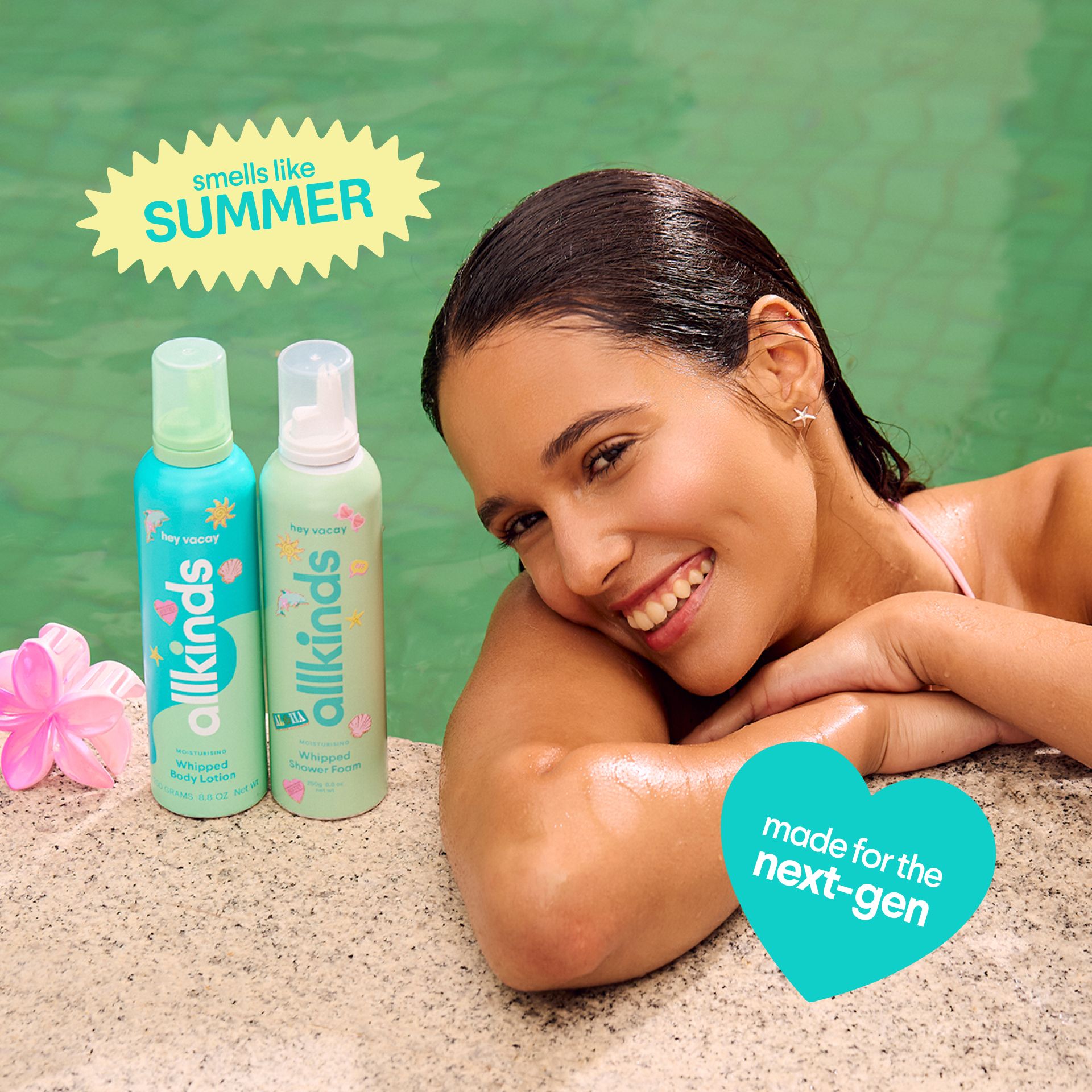 A smiling woman with wet hair leans on a pool edge next to two bottles of allkinds whipped body lotion and shower foam. Text reads "smells like SUMMER" and "made for the next-gen".