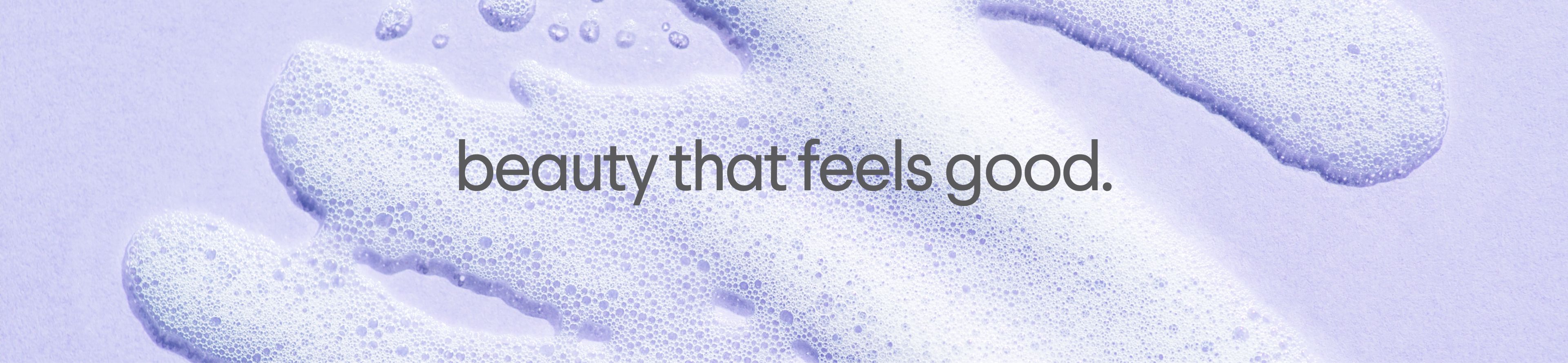 White foam on a lavender background with the text "beauty that feels good."