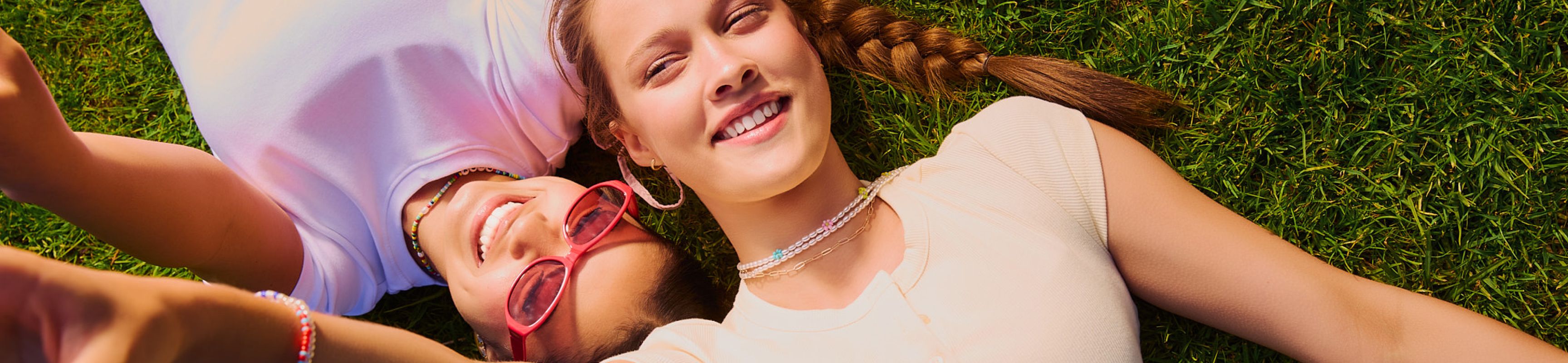 two tubes of lip balm are sitting next to a cake with candy on it .