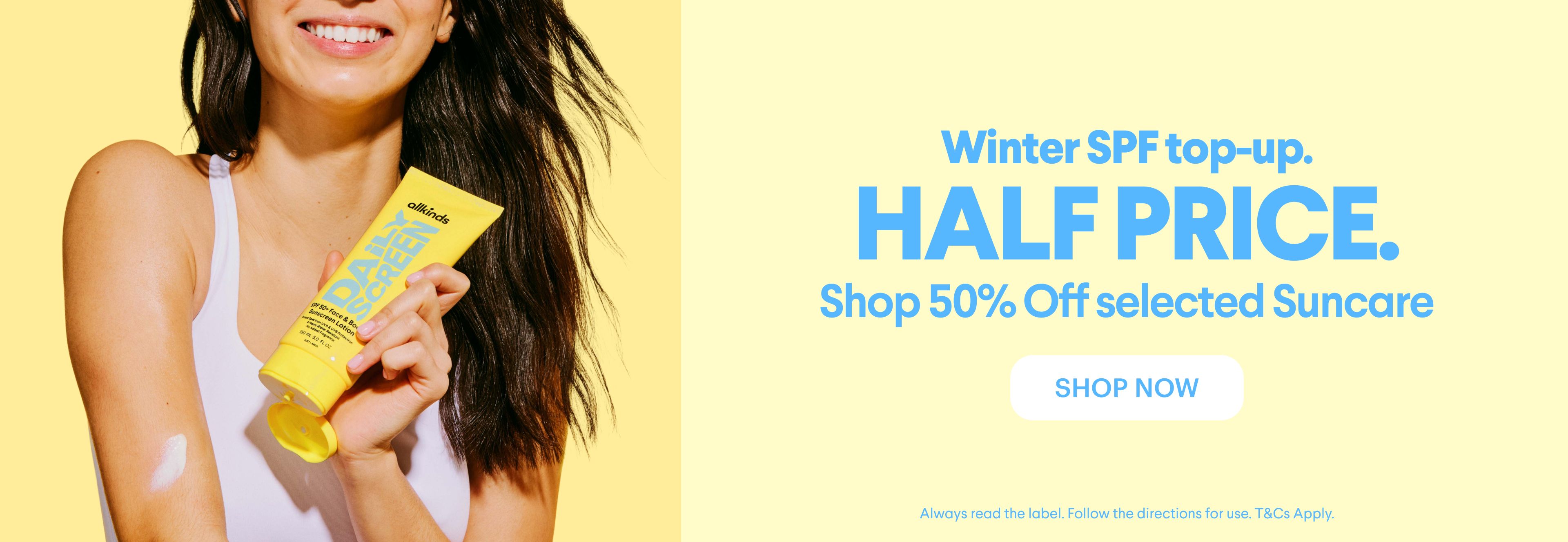 Woman applying sunscreen from a yellow tube, with text: "HALF PRICE. Shop 50% Off selected Suncare."