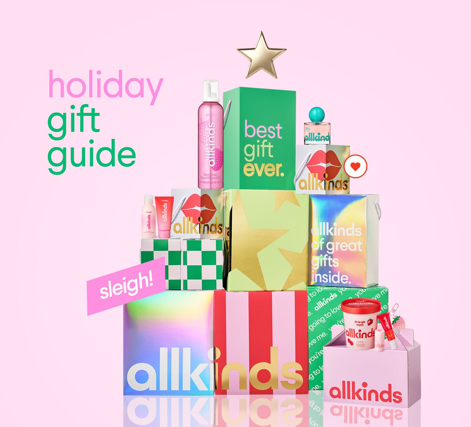 Allkinds holiday gift guide with products and gift boxes arranged like a Christmas tree, topped with a golden star, on a pink background.
