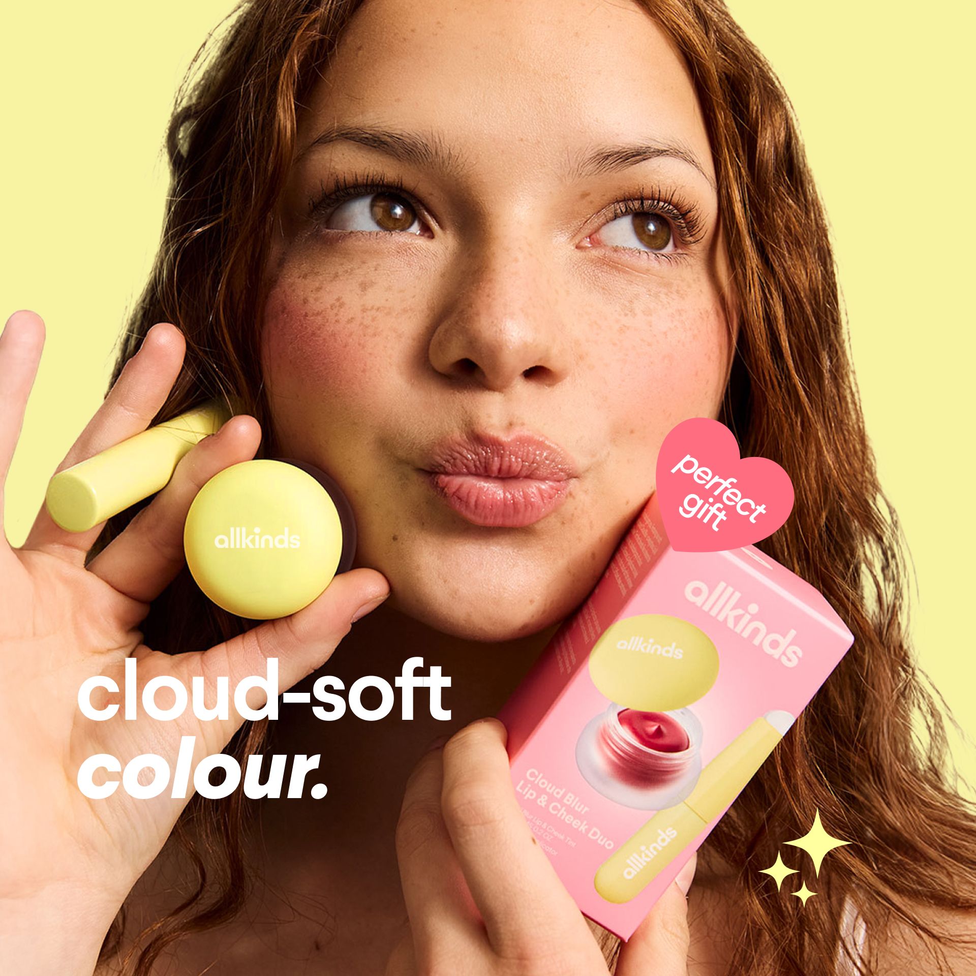 a woman is holding a lip balm and a box of lip balm .