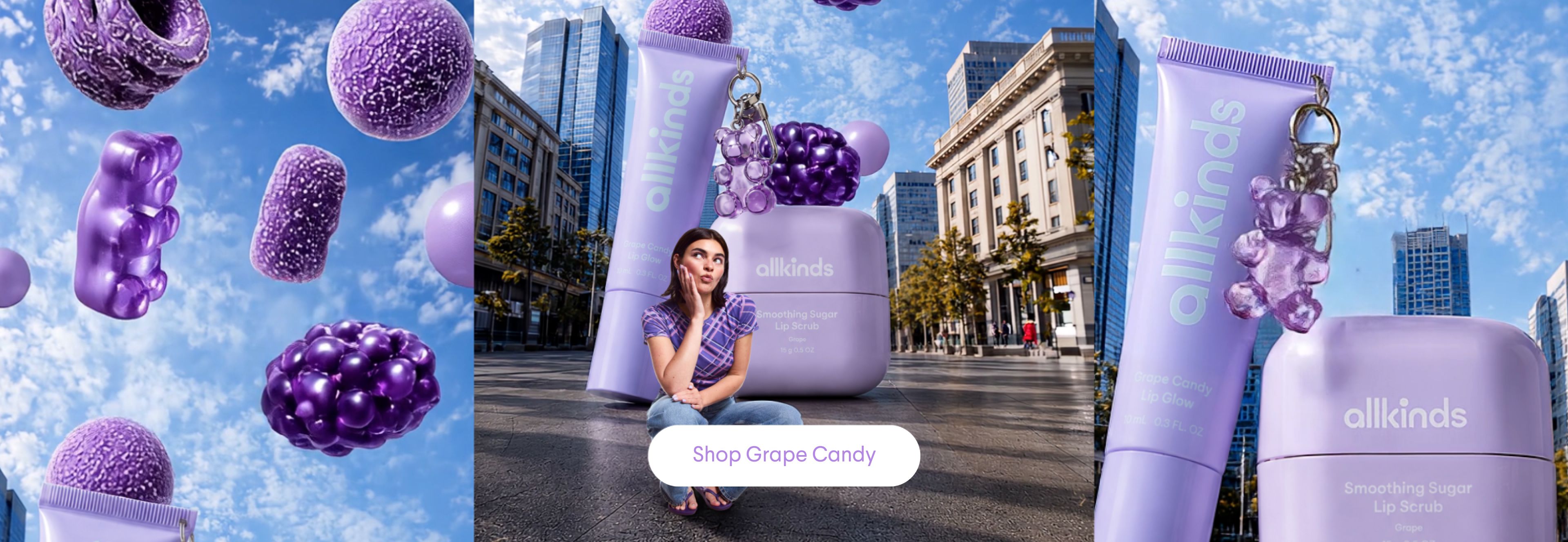 A woman sits on a city street with oversized purple Allkinds lip products, surrounded by various large purple candies floating in the blue sky above. A 'Shop Grape Candy' button is visible.