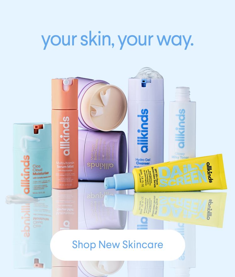 An assortment of colorful Allkinds skincare products on a reflective surface.