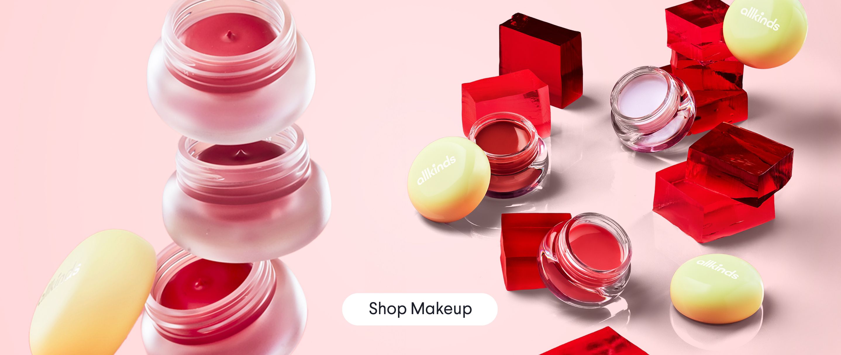 a bunch of jars of makeup are stacked on top of each other on a table .