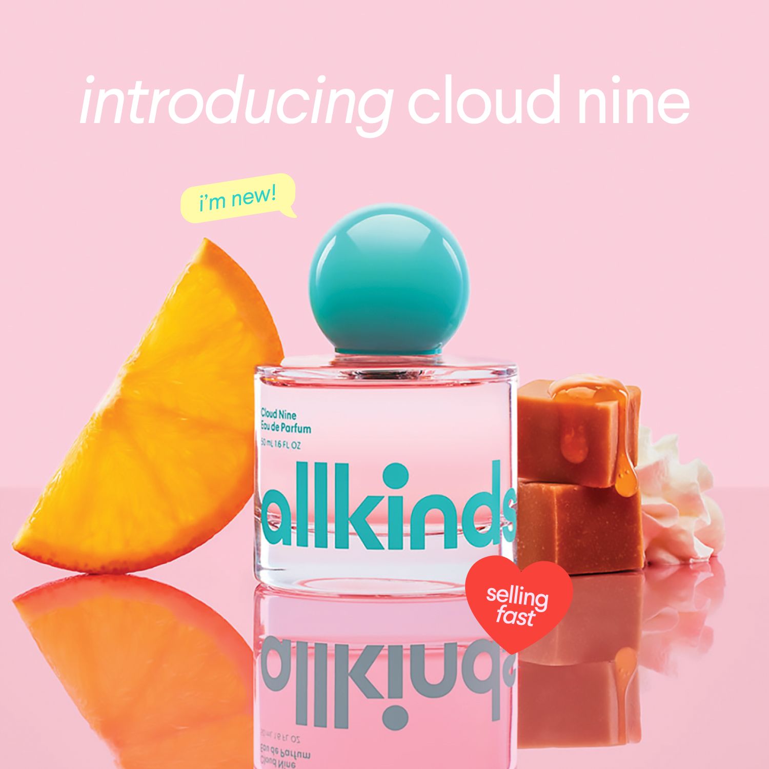 a bottle of perfume is sitting on a table next to a slice of orange and caramel .