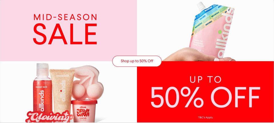 a woman is holding a bottle of lotion next to a sign that says `` up to 50 % off '' .