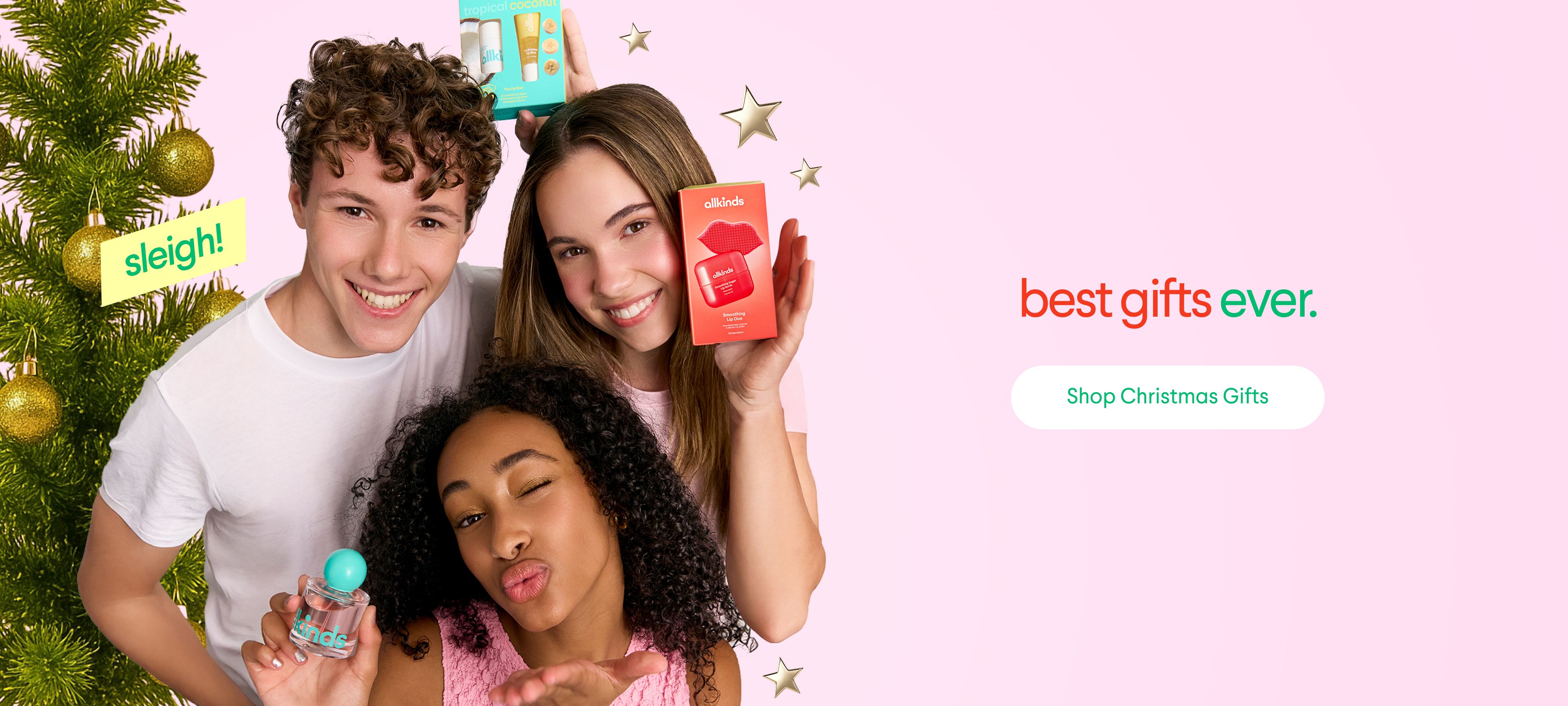 Three smiling young people with beauty gifts and a Christmas tree, next to text "best gifts ever."