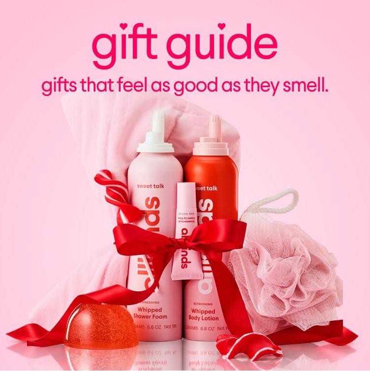 Gift guide for Sweet Talk Spuds body care: pink whipped shower foam, orange whipped body lotion, and lip gloss, tied with a red bow, with a pink loofah, on a pink background.