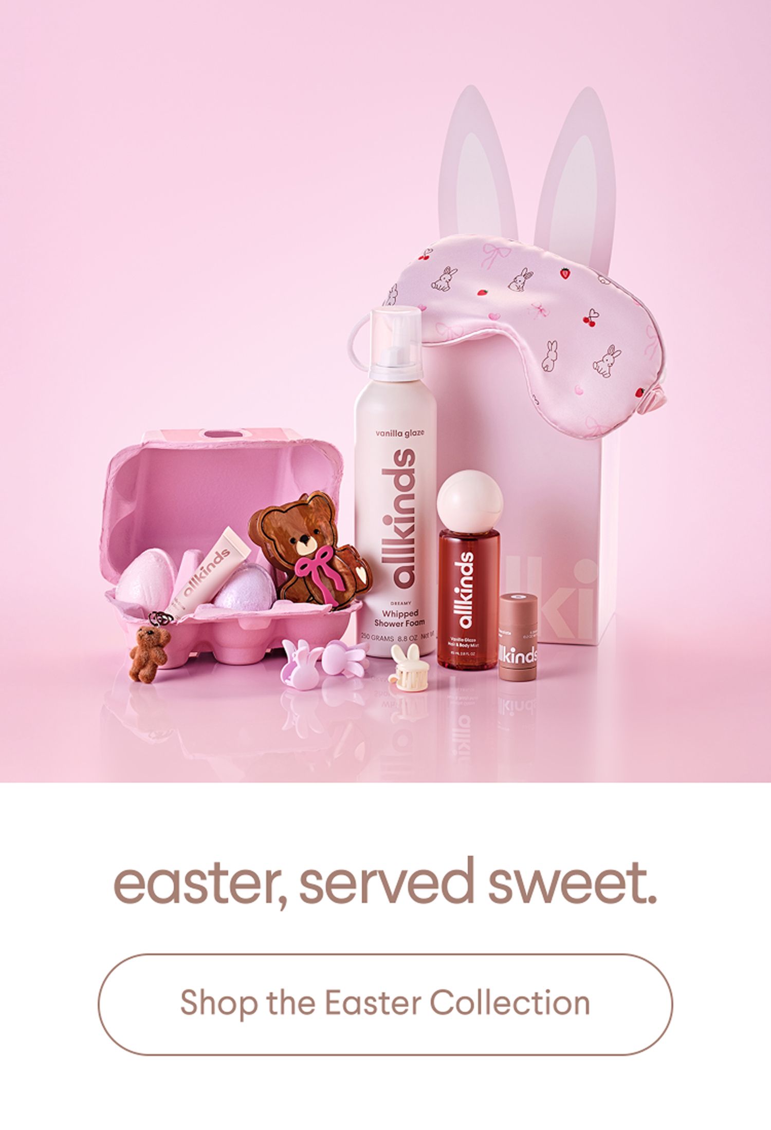 An allkinds Easter collection featuring a bunny sleep mask, shower foam, bath bombs in a pink egg carton, and a chocolate bear on a pink background.