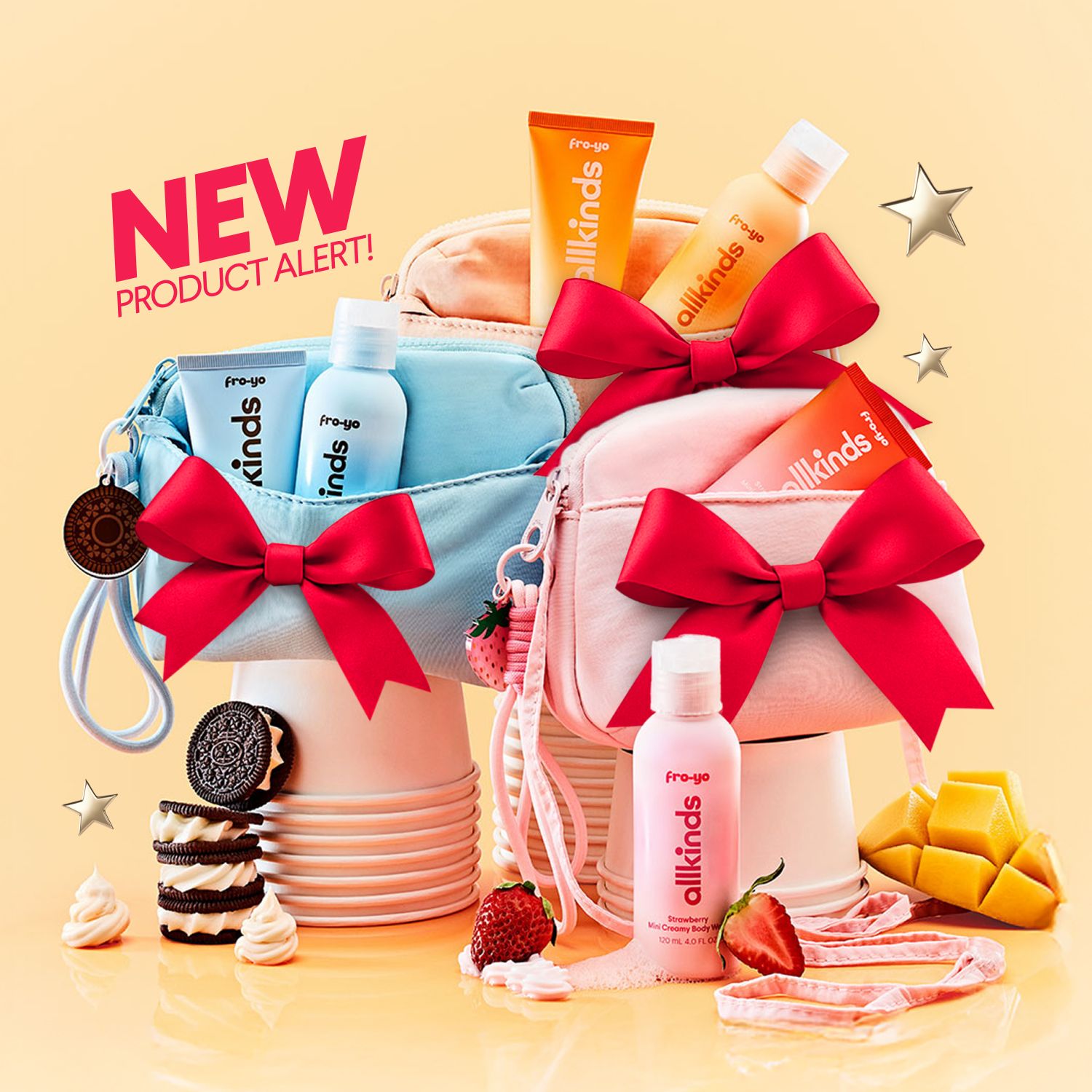 NEW PRODUCT ALERT! banner over Fro-yo allkinds body care products in blue, orange, and pink packaging, some in cosmetic bags with red bows, surrounded by strawberries, mango, and Oreos.